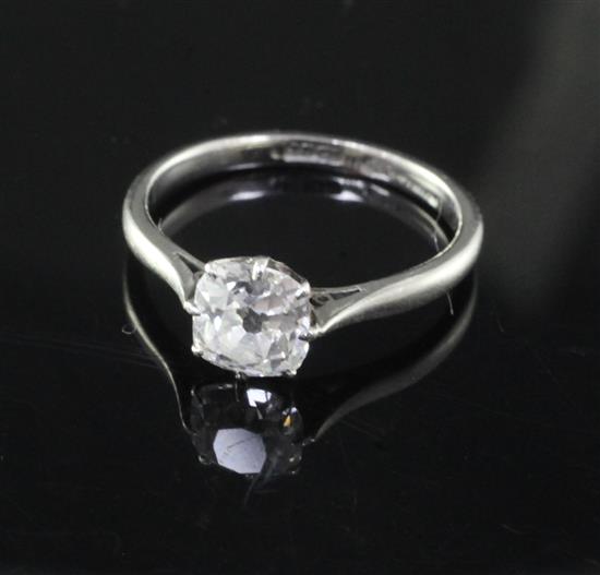An 18ct gold and platinum cushion cut solitaire diamond ring, size M.